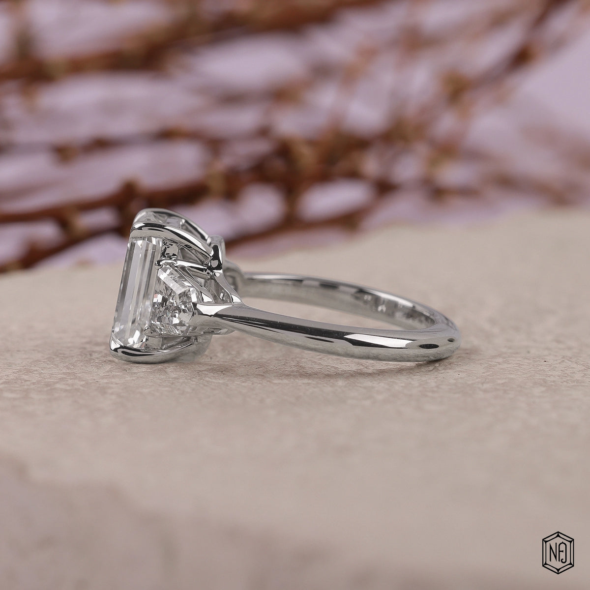 3.06 Carat Emerald Cut Lab Grown Diamond Trellis Three-Stone Engagement Ring - Angled Perspective