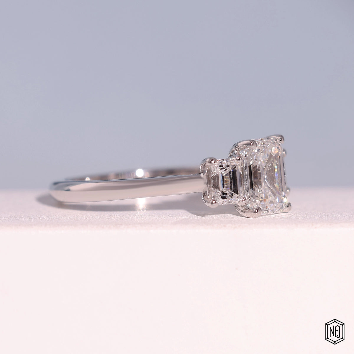 1.24 Carat Emerald Cut Lab Grown Diamond Trellis Three-Stone Engagement Ring - Gallery & Prongs Detail