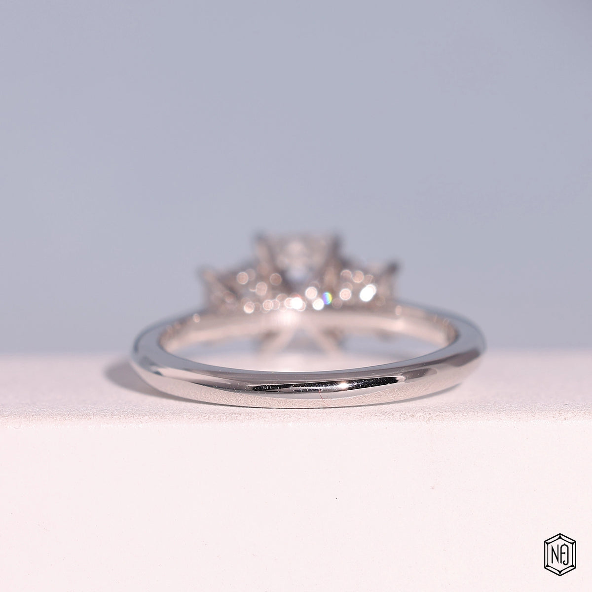 1.24 Carat Emerald Cut Lab Grown Diamond Trellis Three-Stone Engagement Ring - Hand View / Detail Angle