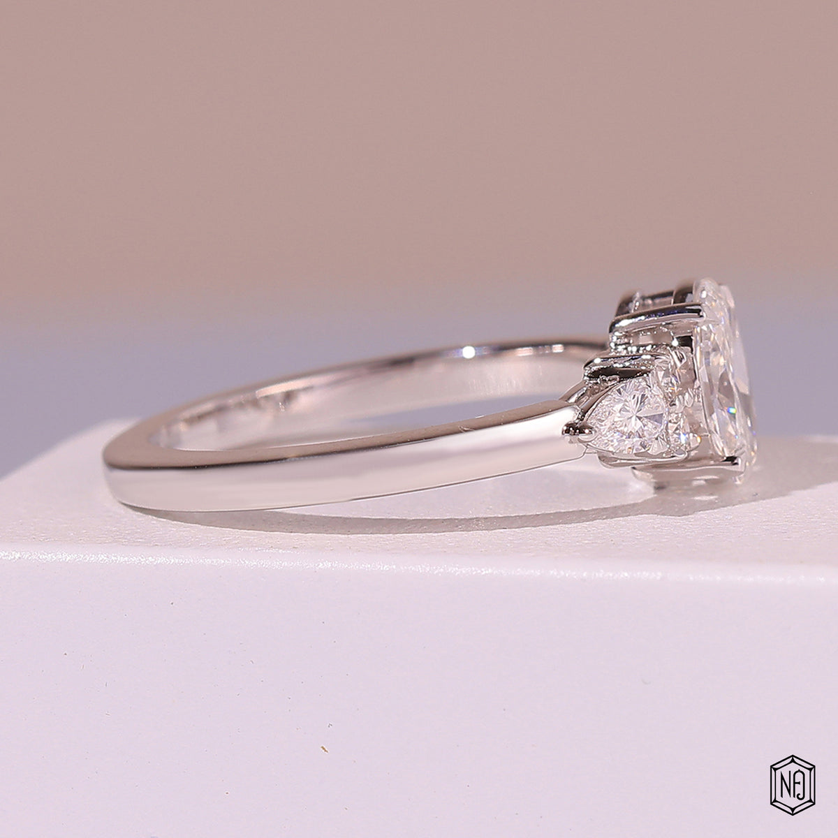 0.72 Carat Oval Cut Lab Grown Diamond Trellis Three-Stone Engagement Ring - Angled Perspective