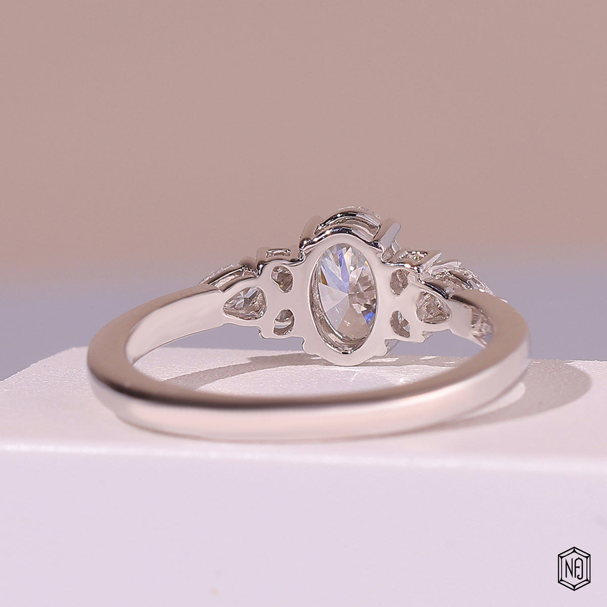 0.72 Carat Oval Cut Lab Grown Diamond Trellis Three-Stone Engagement Ring - Hand View / Detail Angle