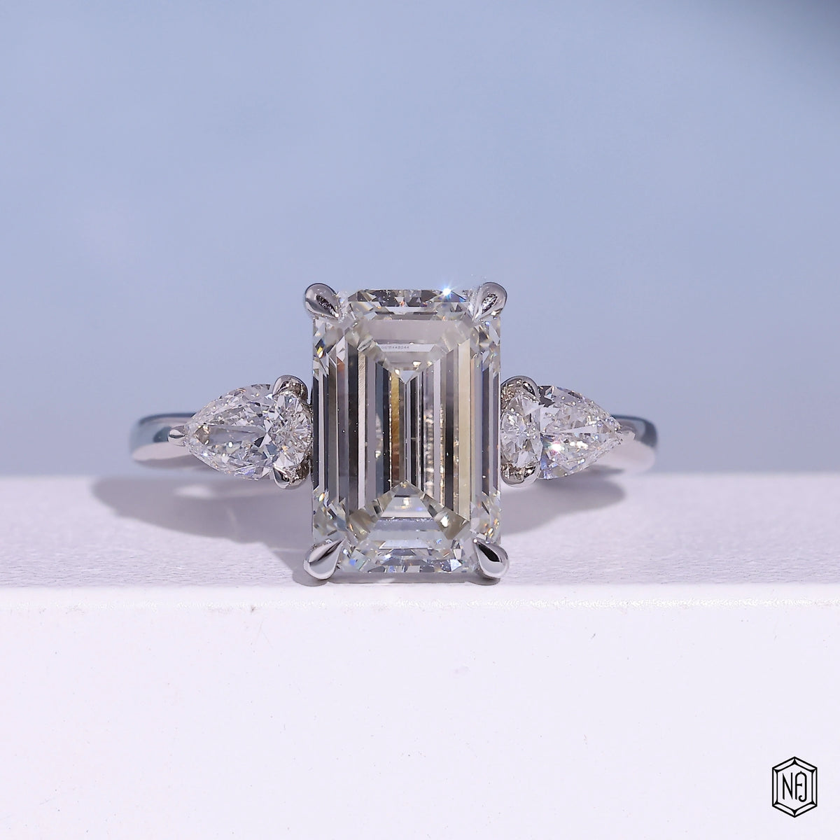 4.71 Carat Emerald Cut Lab Grown Diamond Trellis Three-Stone Engagement Ring - Front Top View