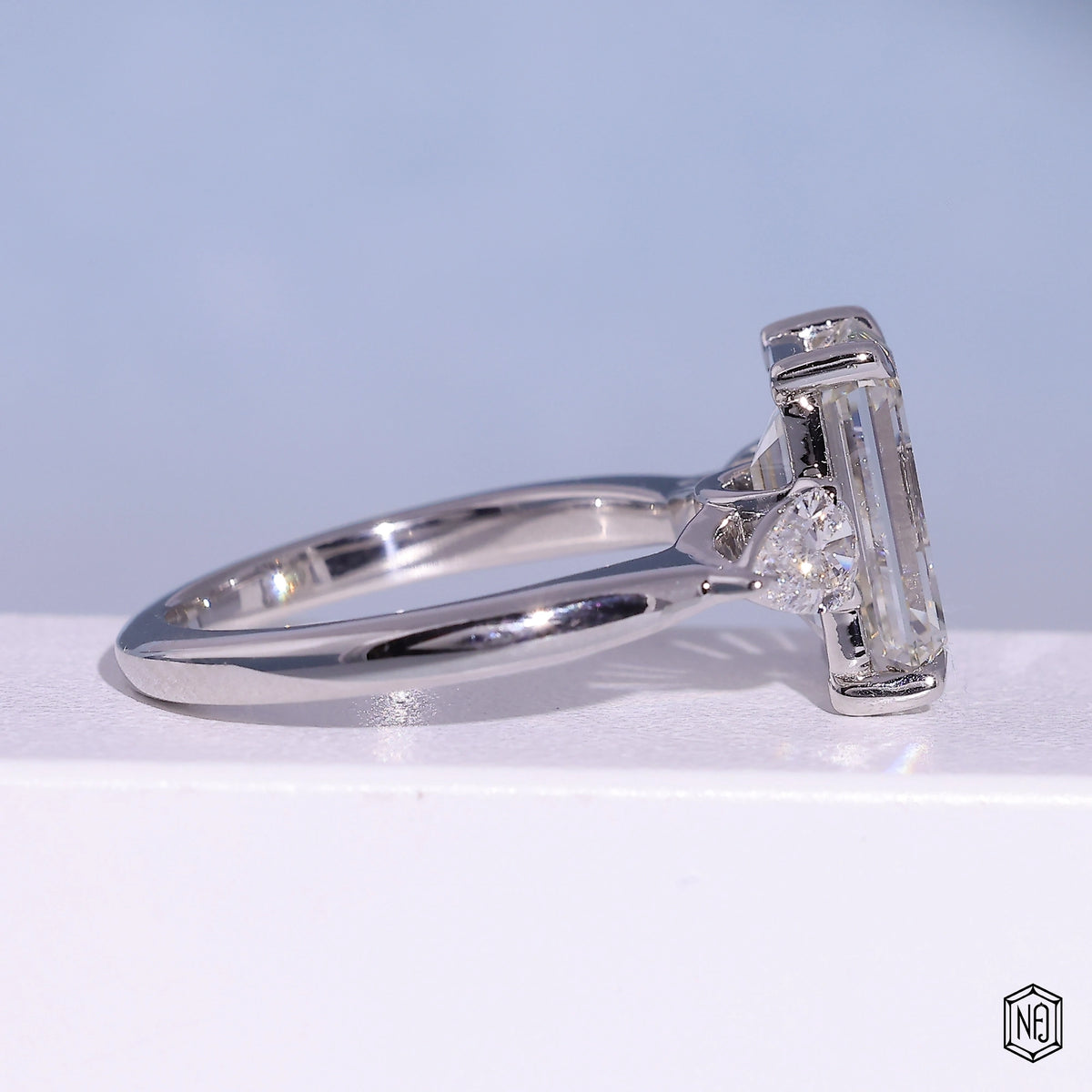 4.71 Carat Emerald Cut Lab Grown Diamond Trellis Three-Stone Engagement Ring - Side Profile Angle