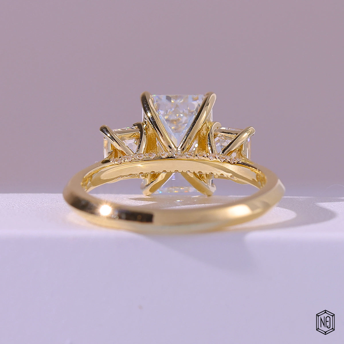 2.99 Carat Emerald Cut Lab Grown Diamond Trellis Three-Stone Engagement Ring - Hand View / Detail Angle
