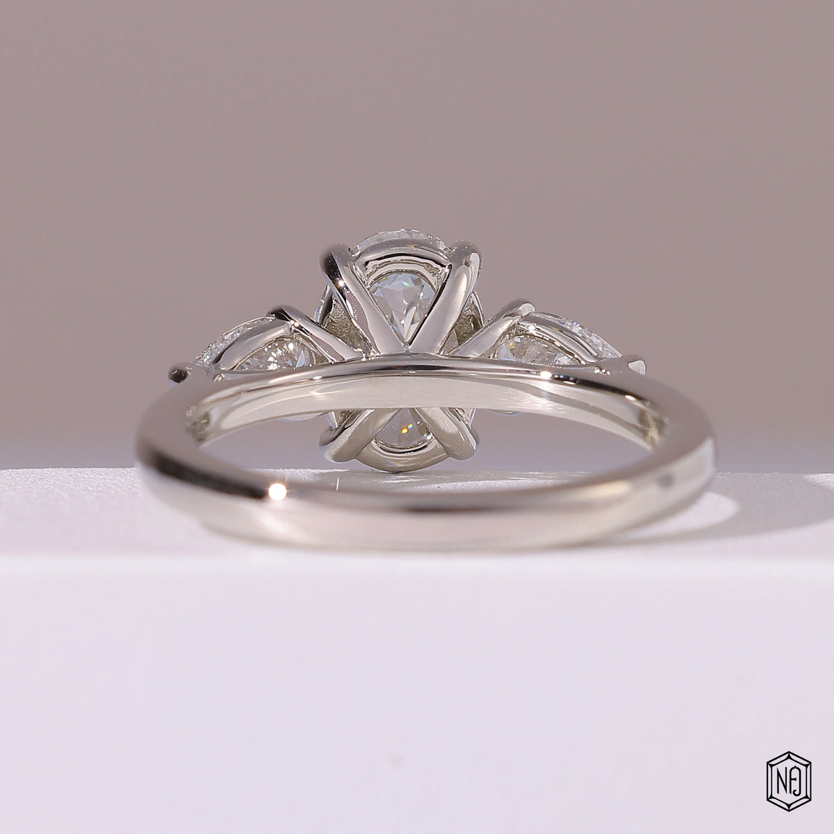 1.5 Carat Oval Cut Lab Grown Diamond Trellis Three-Stone Engagement Ring - Hand View / Detail Angle