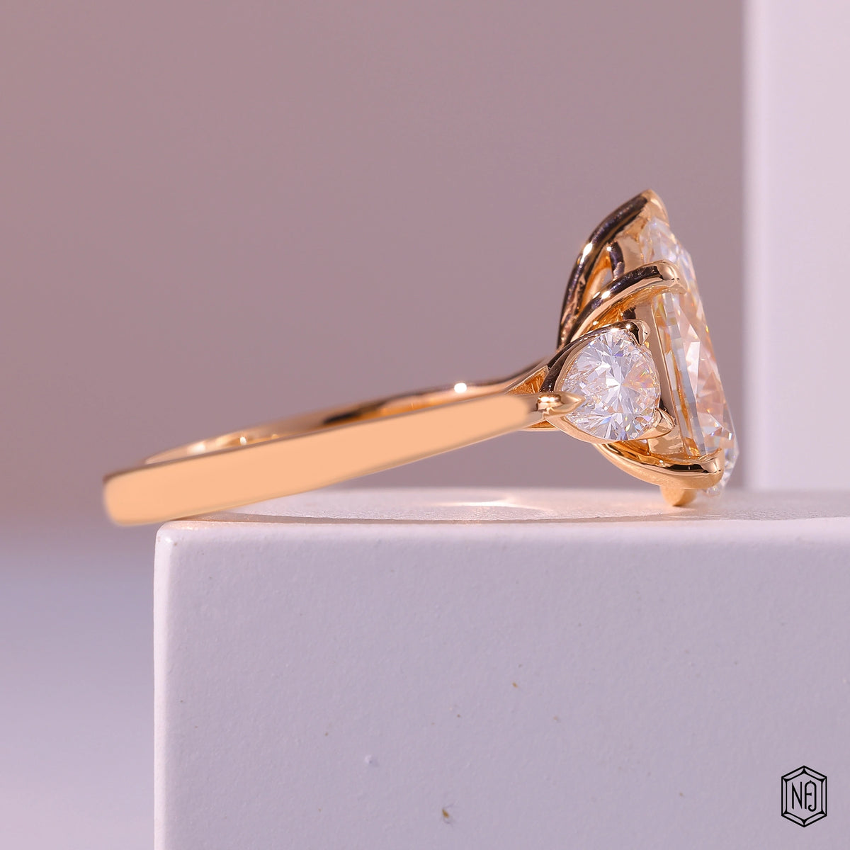 4.01 Carat Pear Cut Lab Grown Diamond Trellis Three-Stone Engagement Ring - Side Profile Angle