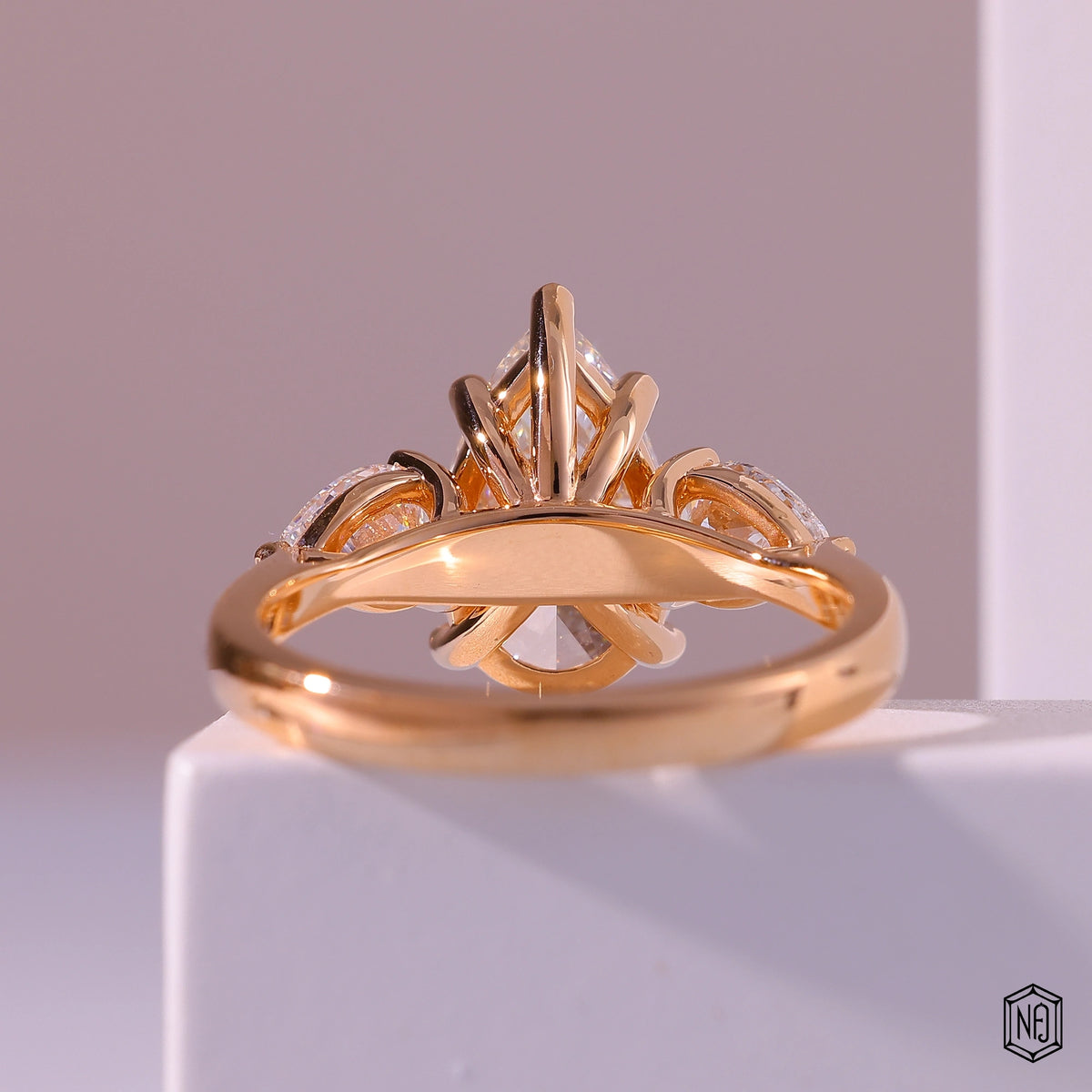 4.01 Carat Pear Cut Lab Grown Diamond Trellis Three-Stone Engagement Ring - Hand View / Detail Angle