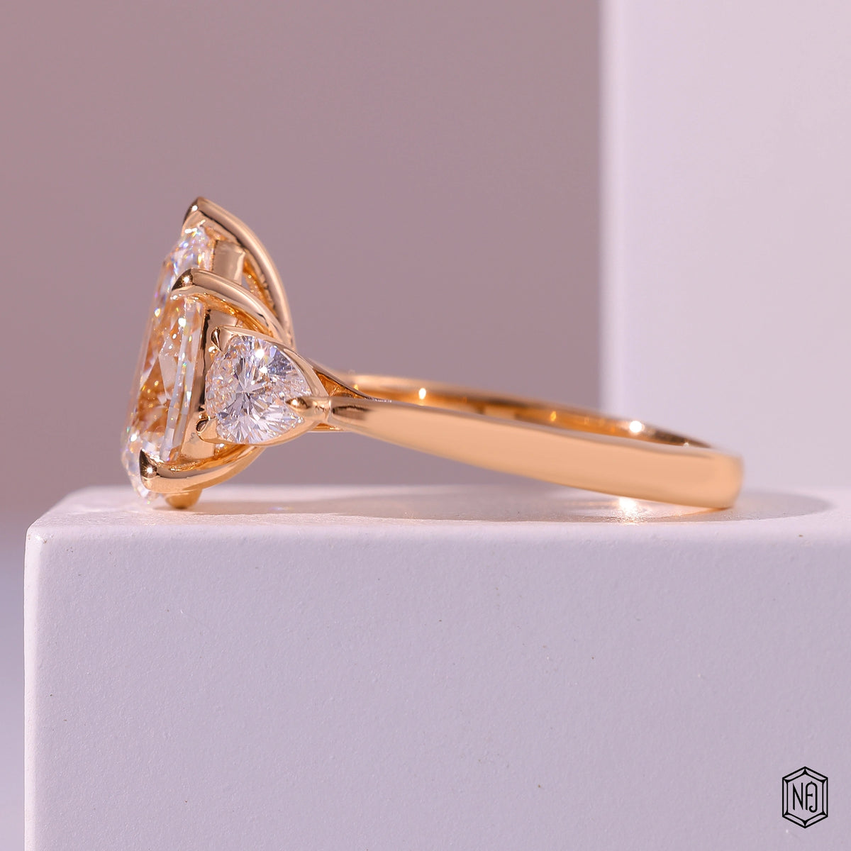 4.01 Carat Pear Cut Lab Grown Diamond Trellis Three-Stone Engagement Ring - Angled Perspective