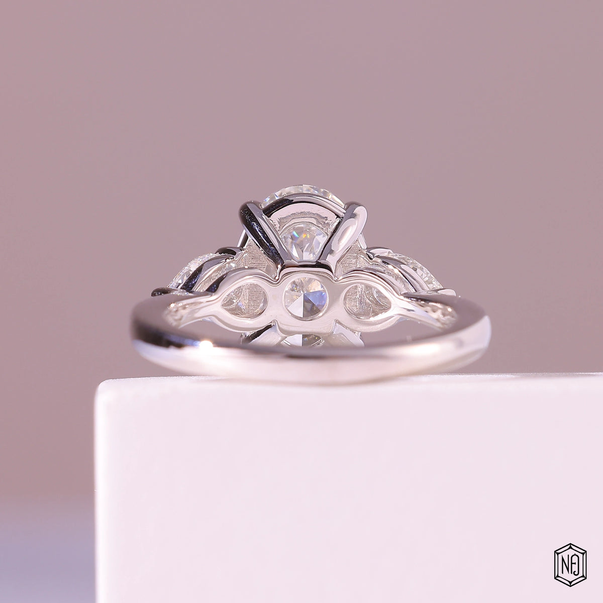 3.19 Carat Oval Cut Lab Grown Diamond Trellis Three-Stone Engagement Ring - Hand View / Detail Angle