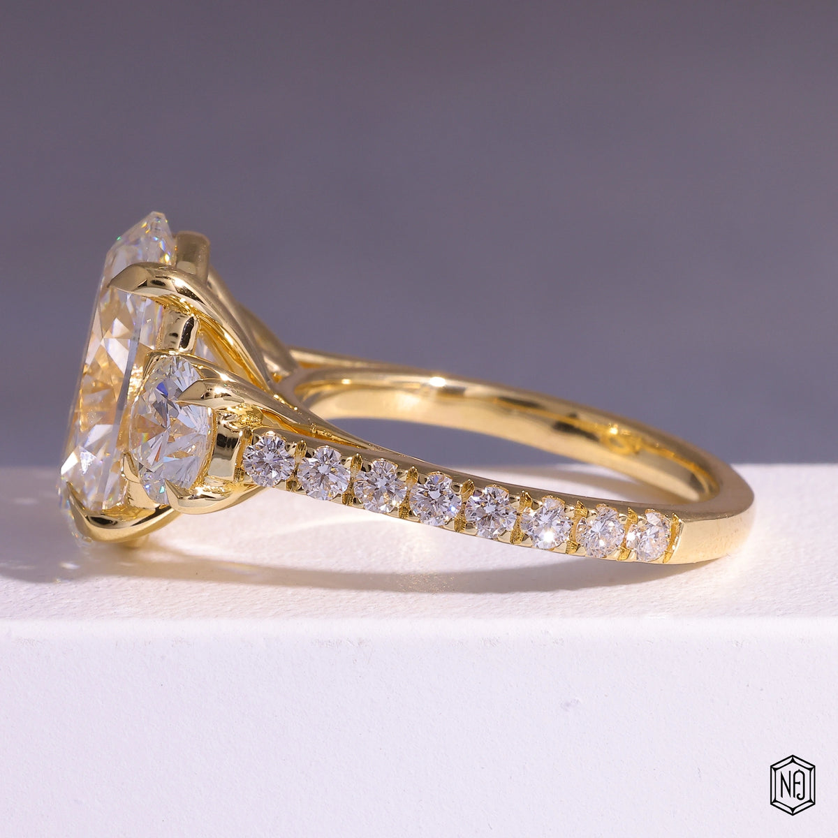 6.08 Carat Oval Cut Lab Grown Diamond Trellis Three-Stone Engagement Ring - Angled Perspective