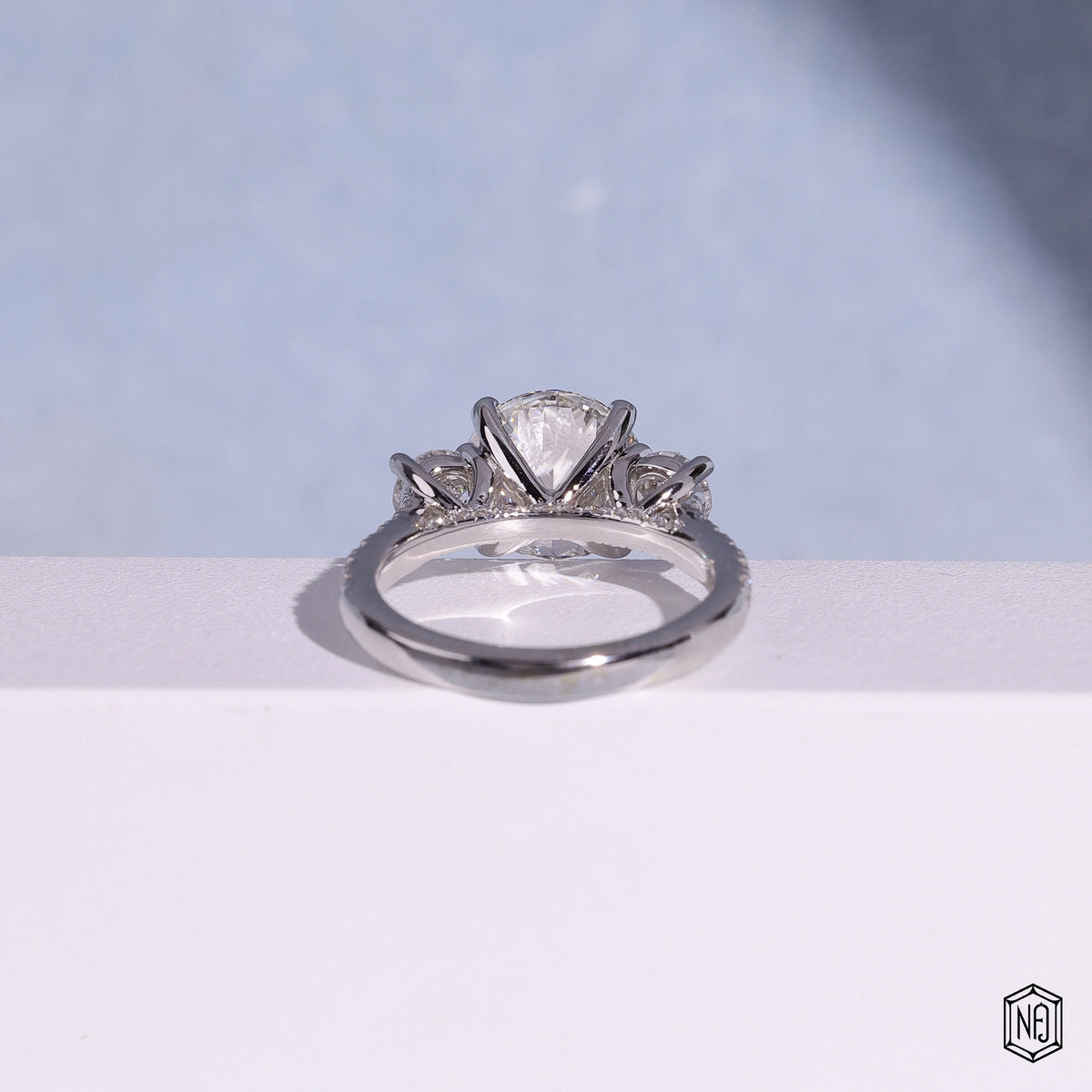 3.12 Carat Round Cut Lab Grown Diamond Trellis Three-Stone Engagement Ring - Hand View / Detail Angle
