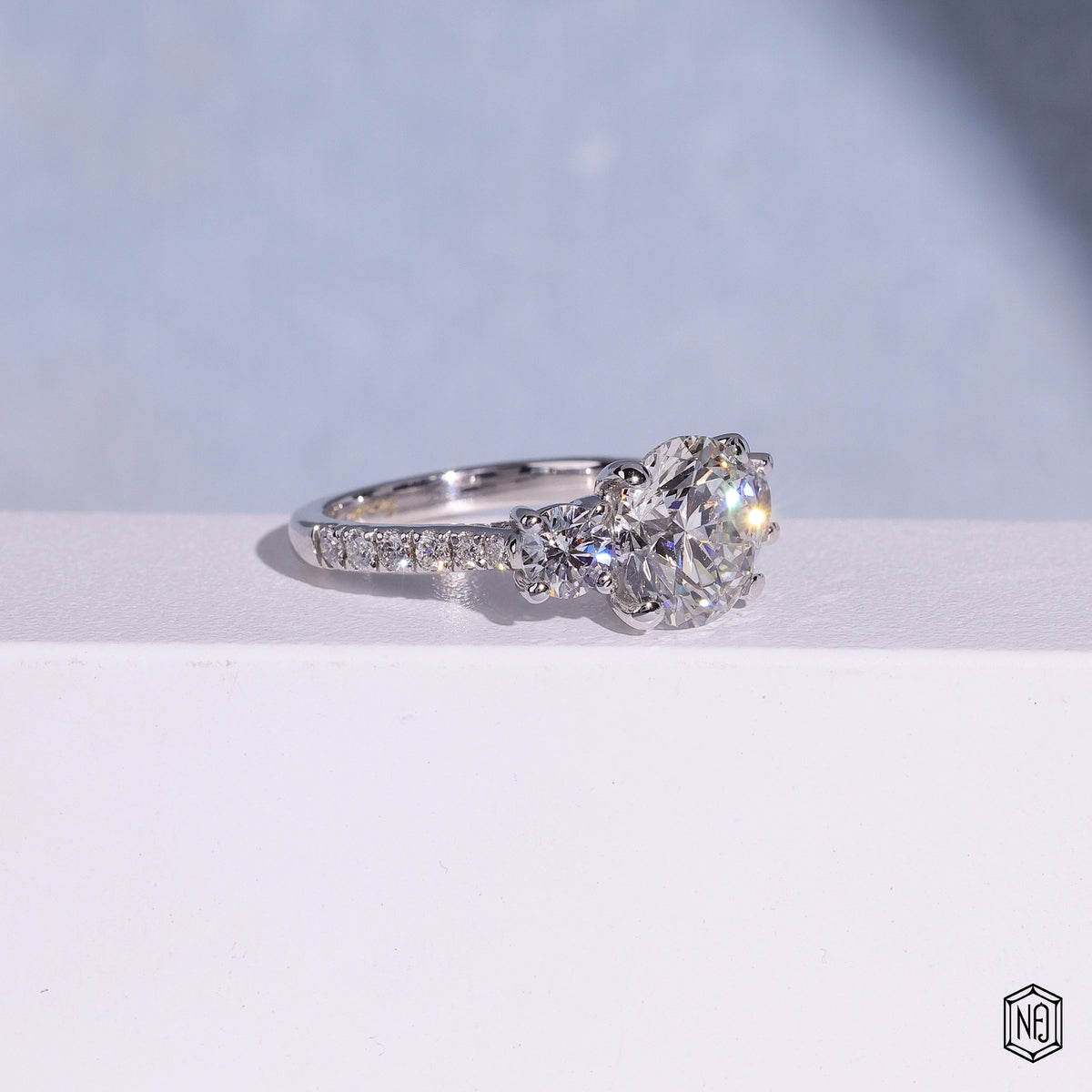 3.12 Carat Round Cut Lab Grown Diamond Trellis Three-Stone Engagement Ring - Gallery & Prongs Detail