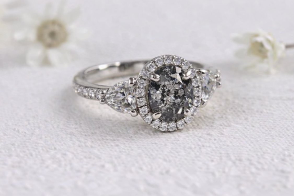 Diamond ring on a white textured surface